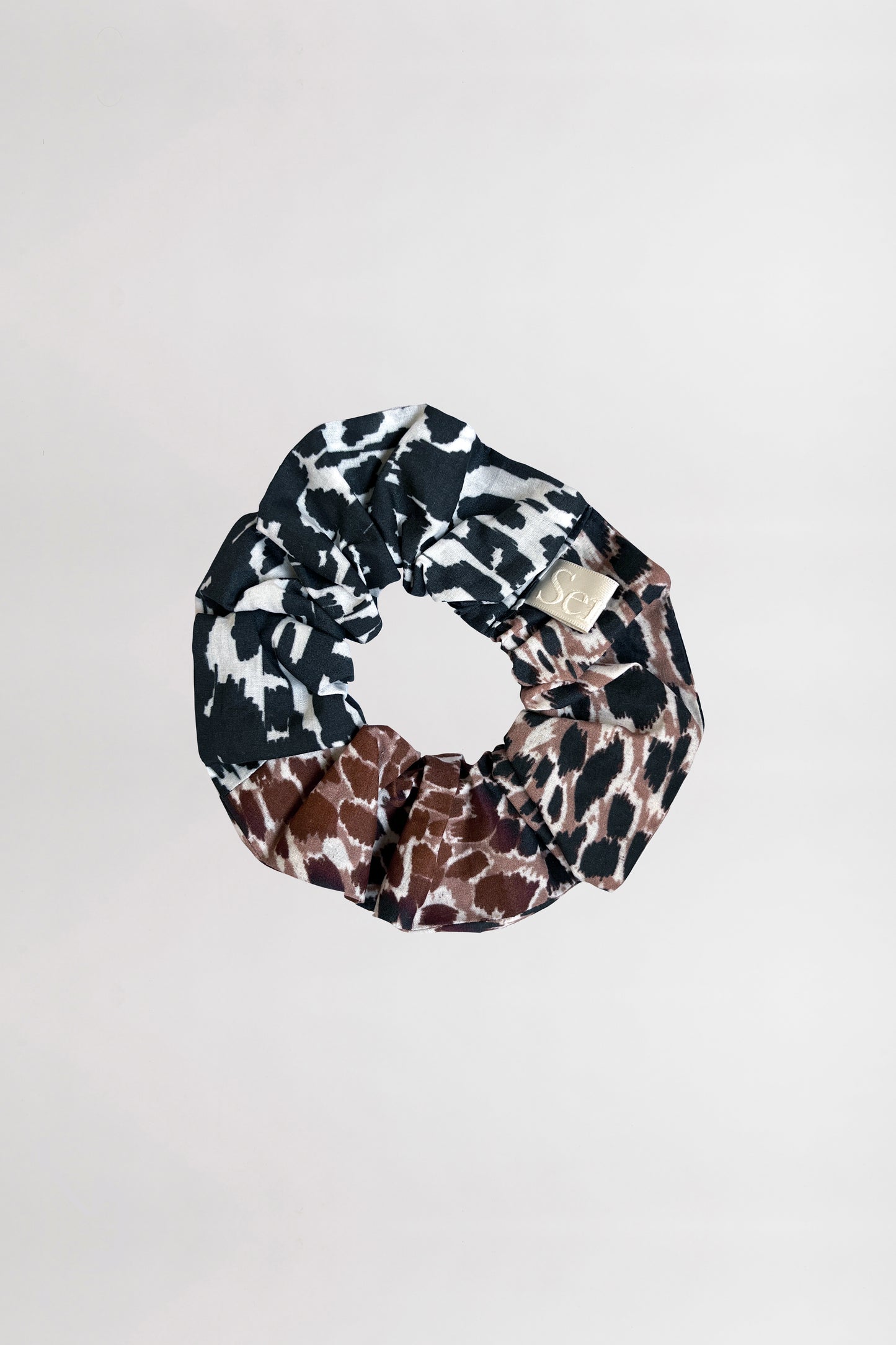 Front view of an animal-printed scrunchie crafted from 100% organic cotton on a neutral background.