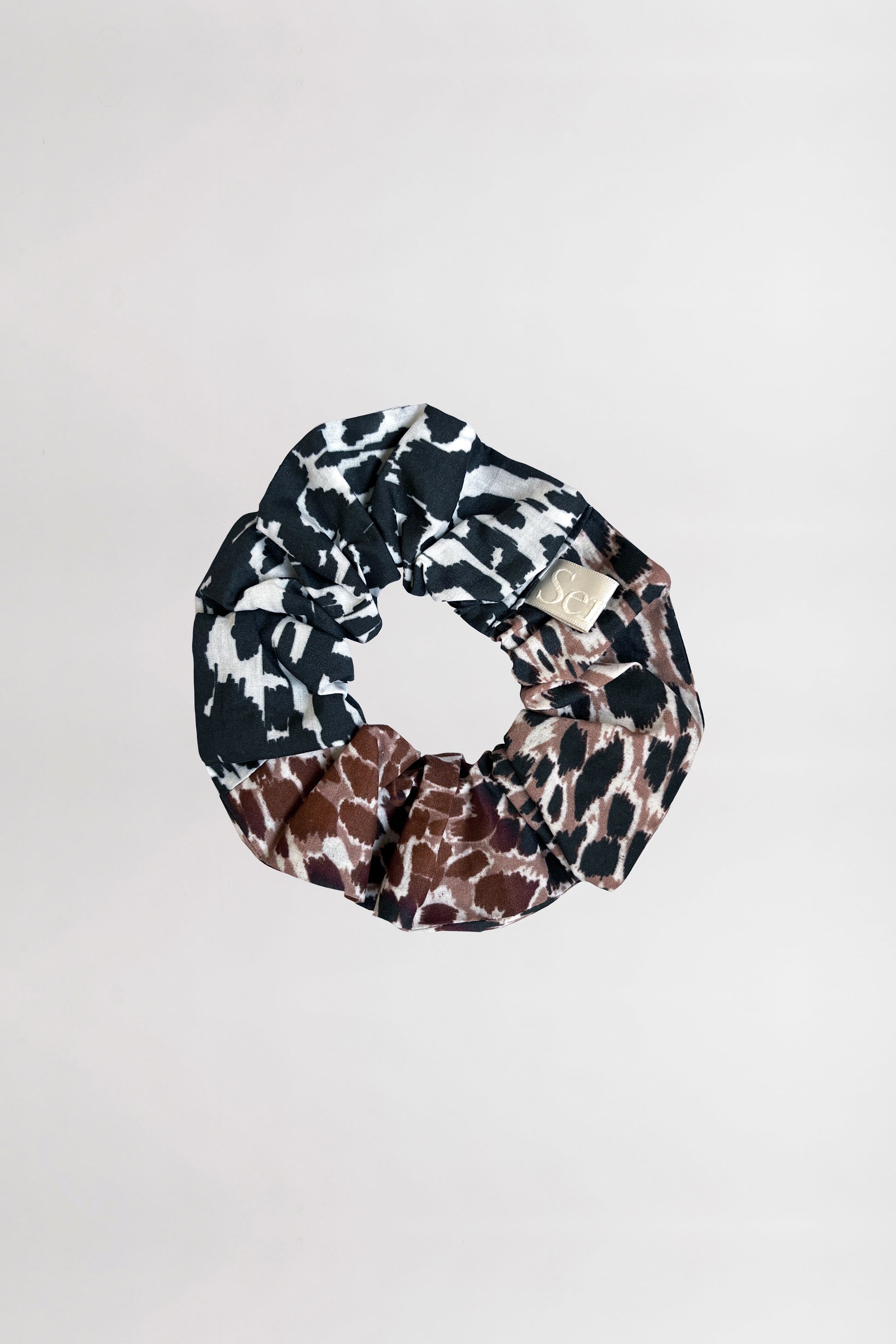 Front view of an animal-printed scrunchie crafted from 100% organic cotton on a neutral background.