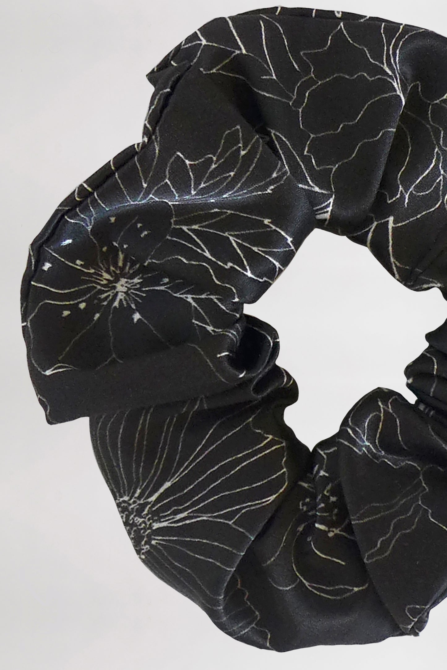 Scrunchie with a linear flower print design in black and white.