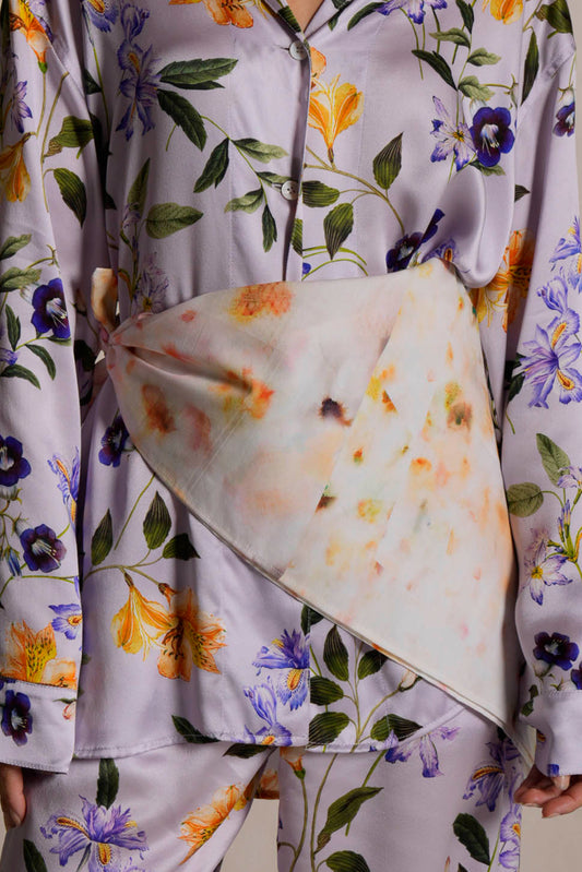 Floral-patterned scarf draped over a floral loungewear with matching shirt and pants.