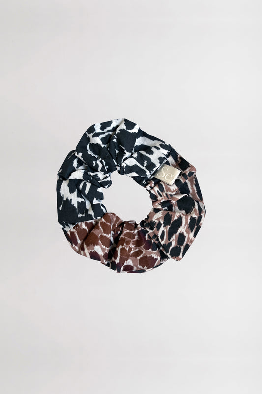 Front view of animal print scrunchie crafted from 100% organic cotton on a neutral background.